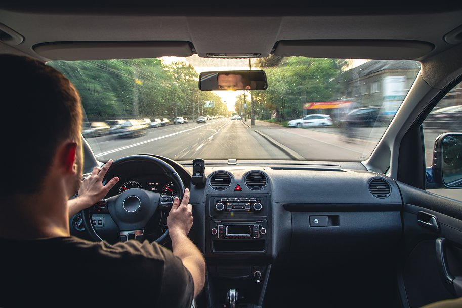 behind the shoulder of a guy driving