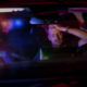 stressed man pulled over with cop lights in back window