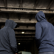 two men in hoodies facing away