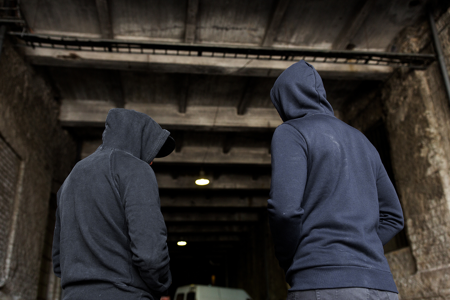 two men in hoodies facing away