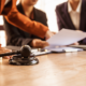 people going over papers with a gavel in focus
