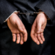 guy in handcuffs in a suit