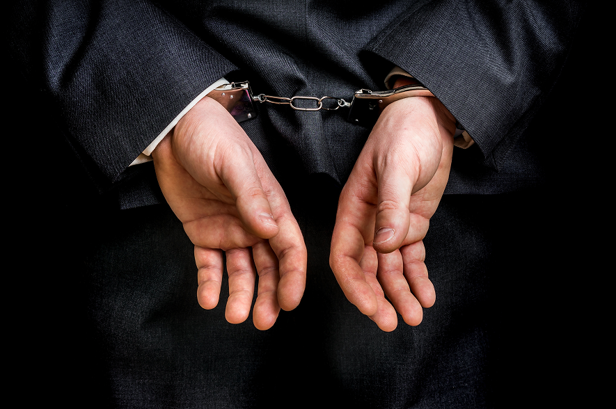 guy in handcuffs in a suit
