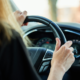 women with hands on the steering wheel